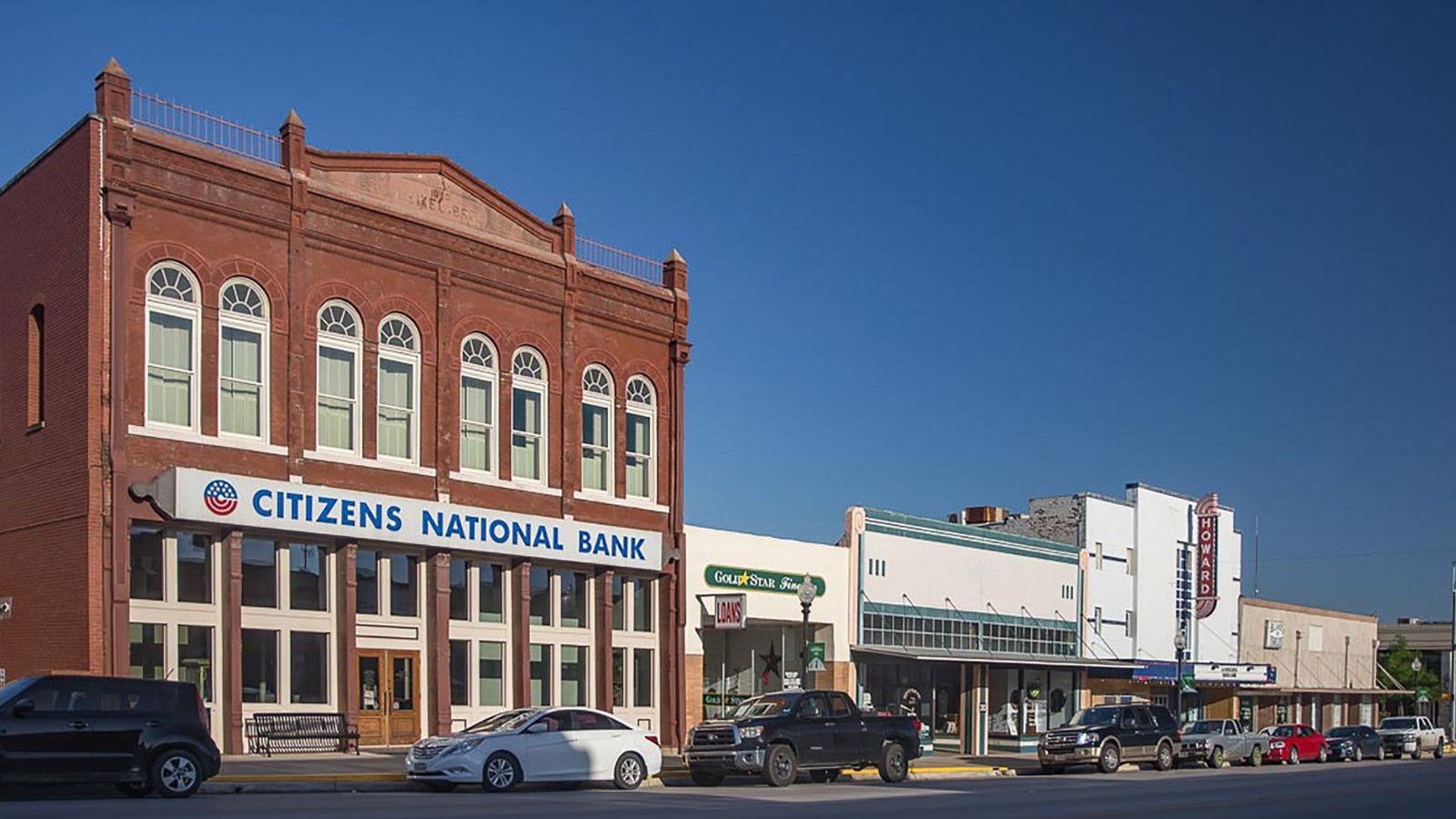 Historic Main Street storefronts including Citizens National Bank and the Howard Theatre in downtown Taylor, Texas